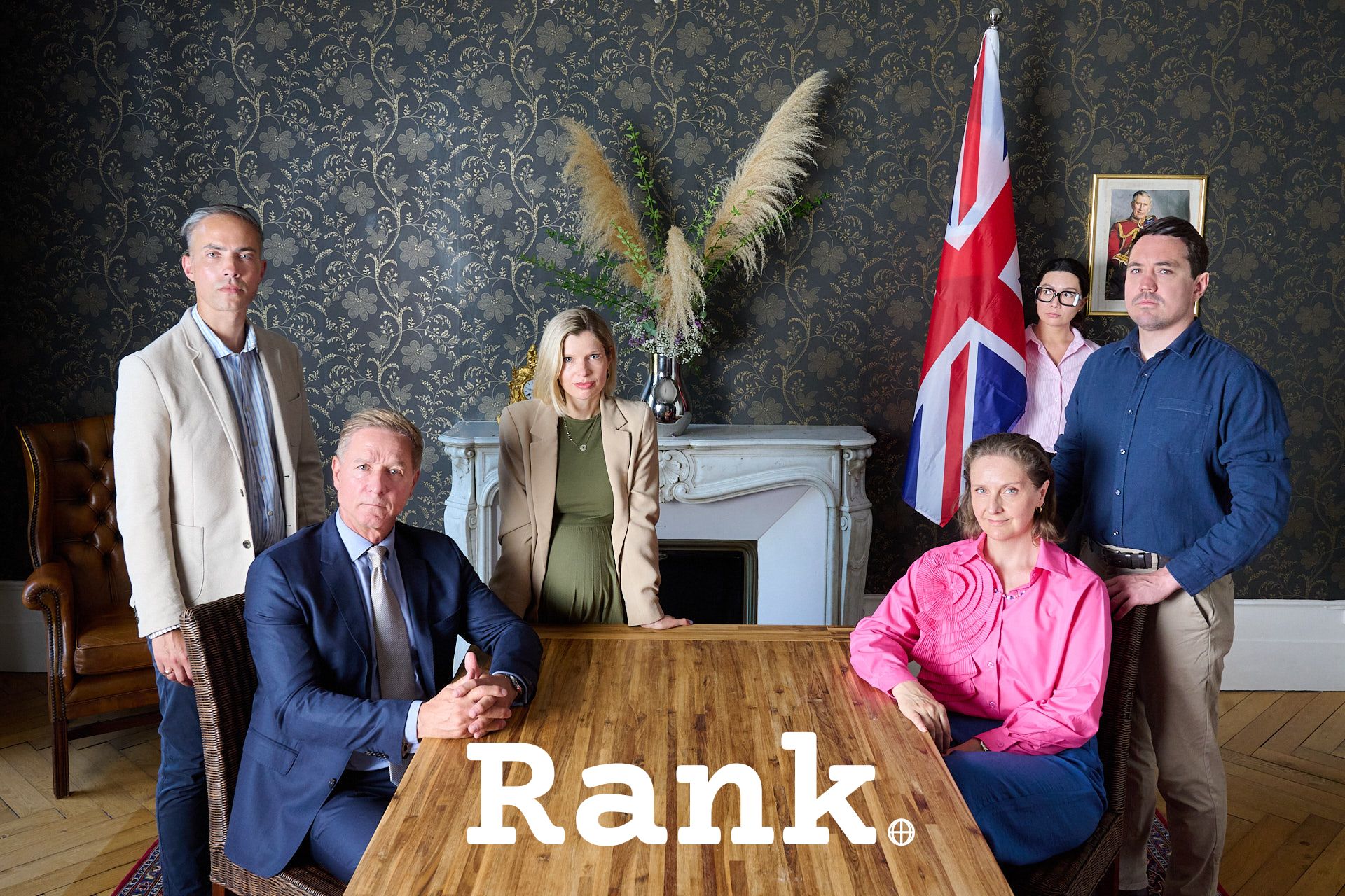 RANK — cast portrait around the embassy table